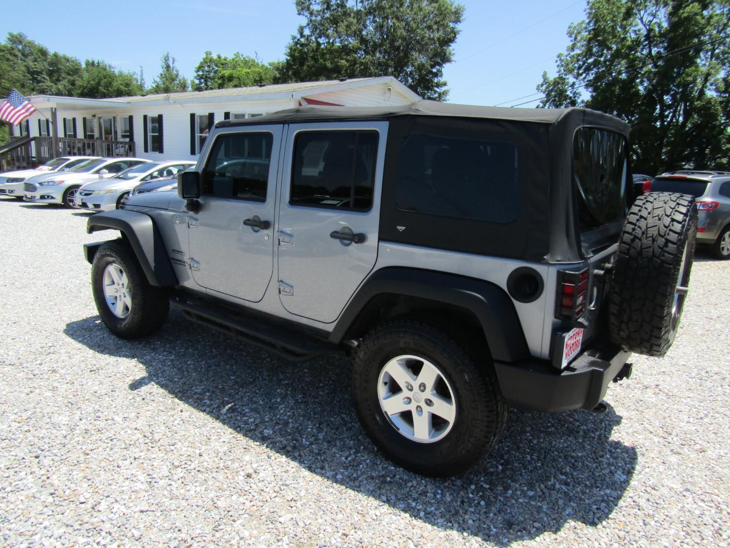 2013 Silver Jeep Wrangler Unlimited Sport 4WD (1C4BJWDG2DL) with an 3.6L V6 DOHC 24V FFV engine, Automatic transmission, located at 15016 S Hwy 231, Midland City, AL, 36350, (334) 983-3001, 31.306210, -85.495277 - Photo#5